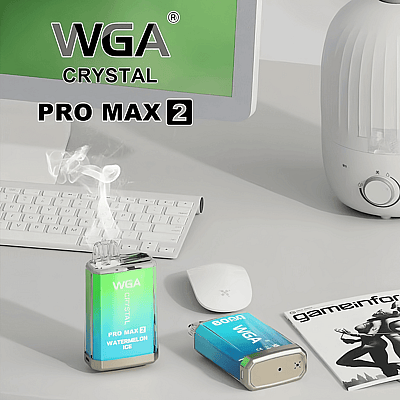 Vape-apparaten met het label "WGA Crystal Pro Max 2 Watermelon Ice" op een bureau met een toetsenbord, muis, tijdschrift en een luchtbevochtiger in de buurt.